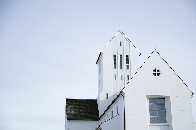 White modernist church in Iceland against a pale sky