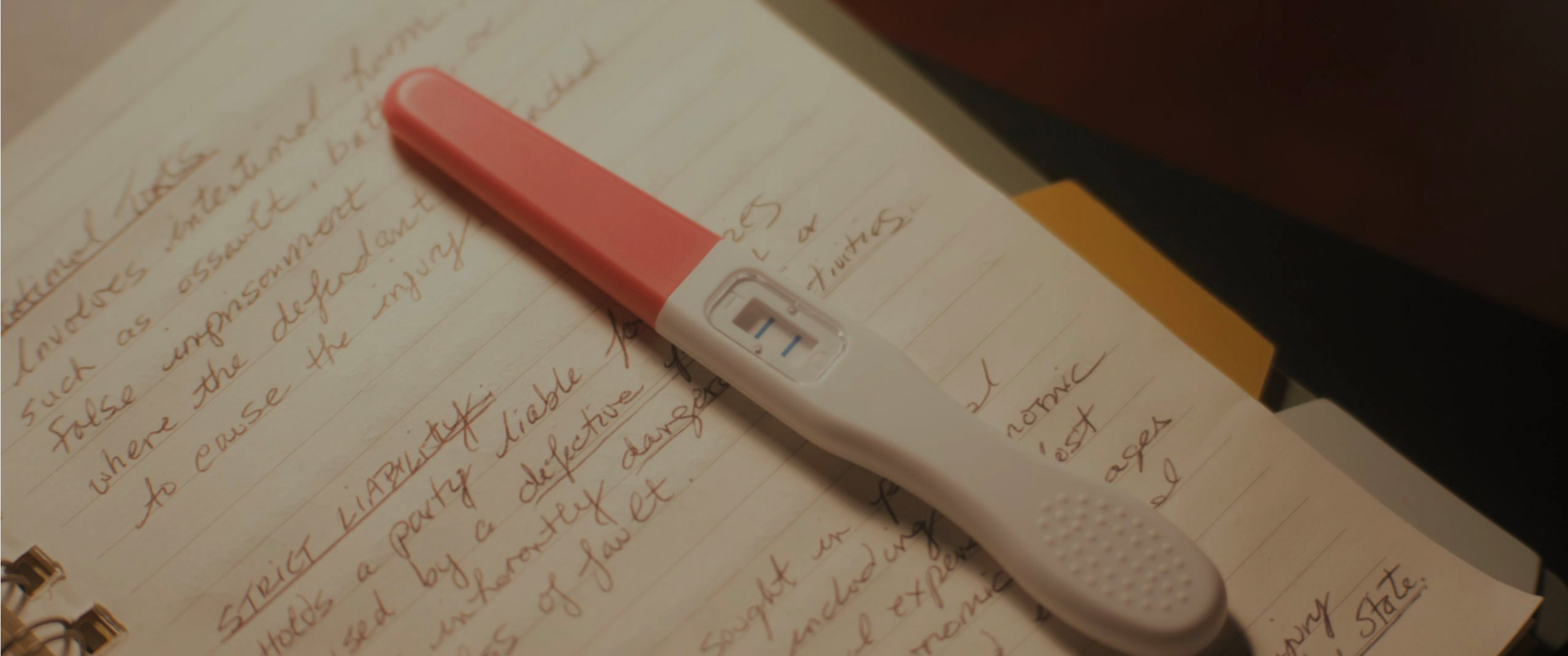 Diana's pregnancy test prop on legal study notes in Tell Me Lies S3 E3
